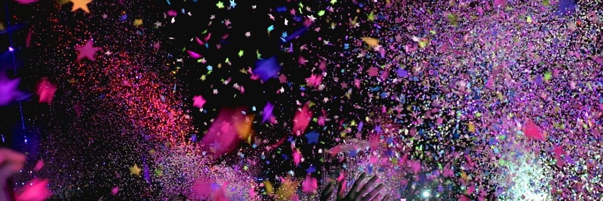 Header_Veranstaltungen. Hände strecken sich im Konfettiregen